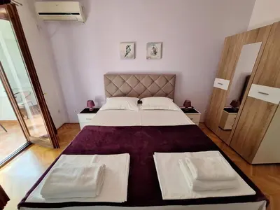 a bedroom with a large bed in a room at Apartmani Hortenzija in Budva