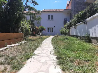 a path in front of a white house at Beach House Buljarica in Petrovac na Moru