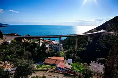 a bridge over a mountain with the ocean in the background at Villa Blue Dreams in Bar