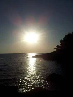 a sun setting over a body of water at Villa Blue Dreams in Bar