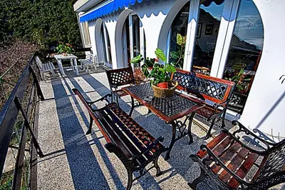 a group of benches and a table on a patio at Villa Blue Dreams in Bar