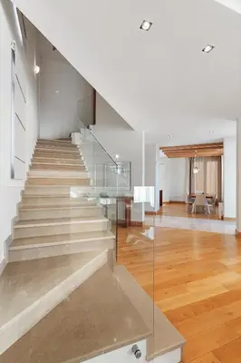 a staircase in a house with a glass railing at Villa Hedonism in Sveti Stefan