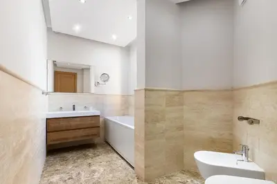 a bathroom with a sink and a tub and a toilet at Villa Hedonism in Sveti Stefan