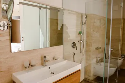 a bathroom with a sink and a shower at Villa Hedonism in Sveti Stefan