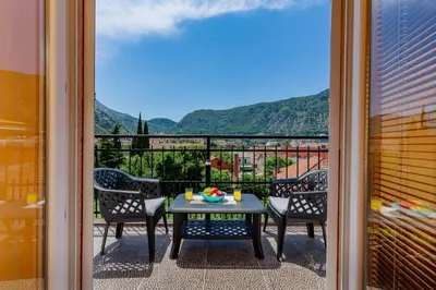 a balcony with a table and chairs and a view at Spacious Central Magik in Kotor