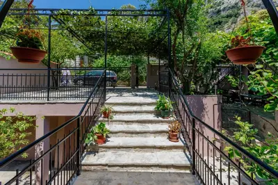a stairway leading up to a house with potted plants at Spacious Central Magik in Kotor