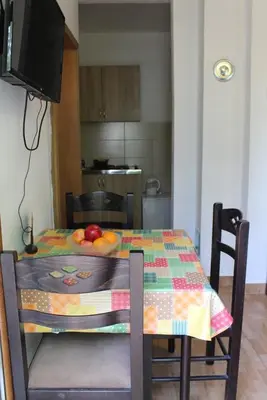 a table with a table cloth with fruit on it at Apartments Olga in Virpazar