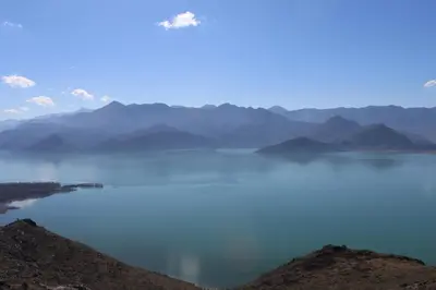 a view of a large body of water with mountains at Apartments Olga in Virpazar