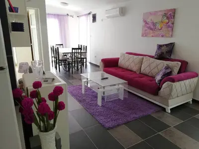 a living room with a red couch and a table at Apartments Pines in Bar