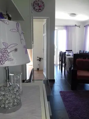 a living room with a table with a lamp on it at Apartments Pines in Bar