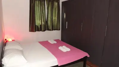 a bedroom with a bed with two towels on it at Apartments Pines in Bar