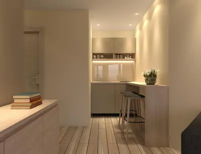 a kitchen with a counter and a bar with a stool at Twister Apartments in Budva