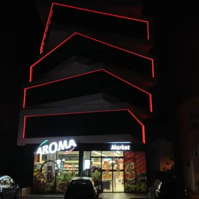 a store with a neon sign in front of it at Twister Apartments in Budva