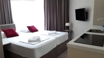 a hotel room with a bed and a sink at Twister Apartments in Budva