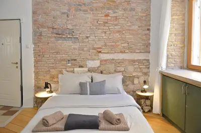 a bedroom with a brick wall and a bed at Charming apartment in Kotor in Kotor