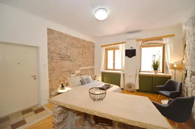 a living room with a bed and a couch at Charming apartment in Kotor in Kotor