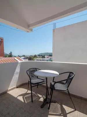 a table and two chairs on a balcony at Mediterranean Guest House Balkan in Budva