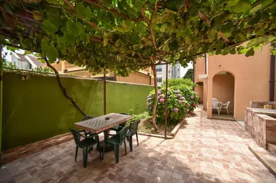 a patio with a table and chairs in a courtyard at MG apartments and rooms in Budva