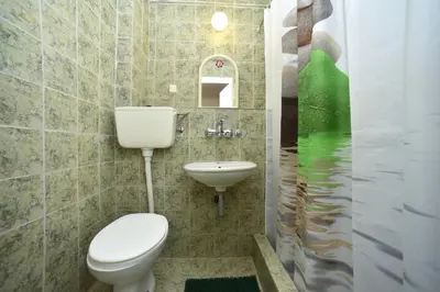 a bathroom with a toilet and a sink at MG apartments and rooms in Budva