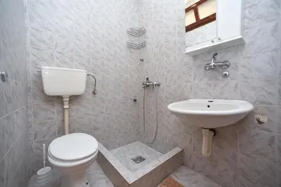 a bathroom with a toilet and a sink at MG apartments and rooms in Budva
