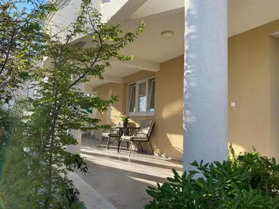 a porch of a house with chairs and a table at Dajkovic Apartmani in Bar