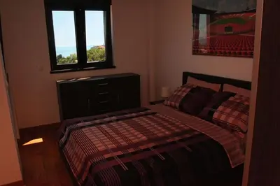 a bedroom with a bed and a window at Apartment Obradovic in Budva