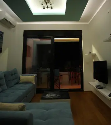 a living room with a couch and a tv at Apartment Obradovic in Budva