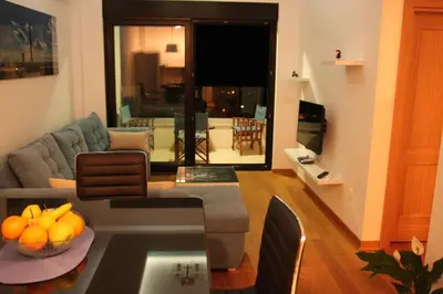 a living room with a couch and a table at Apartment Obradovic in Budva