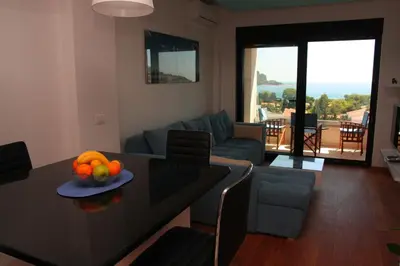 a living room with a table with a bowl of fruit on it at Apartment Obradovic in Budva