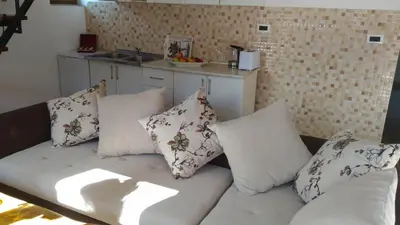 a couch with pillows on it in a kitchen at Apartment Mond in Virpazar