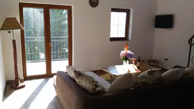 a living room with a couch and a table at Apartment Mond in Virpazar
