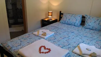 a bedroom with a bed with towels on it at Apartment Mond in Virpazar