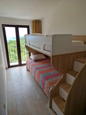 a room with two bunk beds and a balcony at Villa Old Olive 2 in Budva