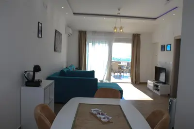 a living room with a blue couch and a table at Apartment Stojanovic in Bar