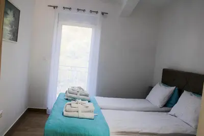 a room with two beds with towels on them at Apartment Stojanovic in Bar