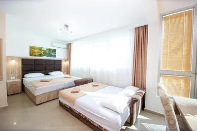 a hotel room with two beds and a window at Apartment Sofija in Budva