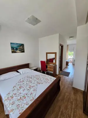 a bedroom with a bed and a desk at Casa ROBI - Apartments in Ulcinj