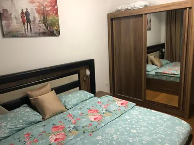 a small bedroom with a bed and a mirror at Apartment Veselin in Budva