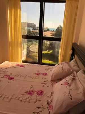 a bedroom with a bed and a large window at Apartment Veselin in Budva