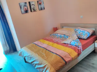 a bedroom with a bed with a colorful blanket at Apartment Sea Space in Dobra Voda
