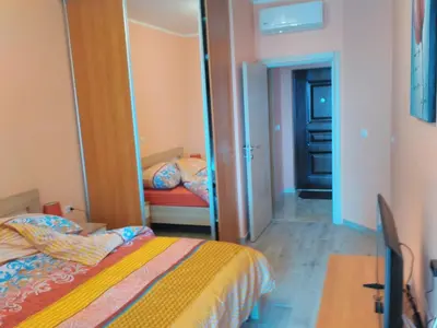 a bedroom with a bed and a mirror at Apartment Sea Space in Dobra Voda