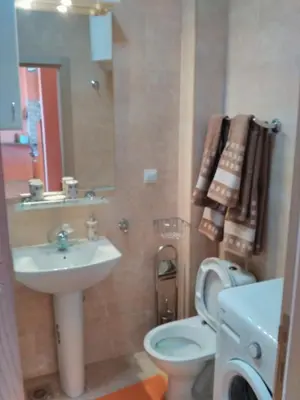 a bathroom with a sink and a toilet and a mirror at Apartment Sea Space in Dobra Voda