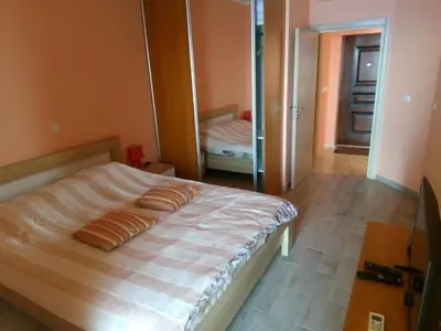 a bedroom with a bed and a mirror at Apartment Sea Space in Dobra Voda