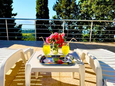 a white table with two glasses and flowers on it at Holiday Home Viko in Sutomore