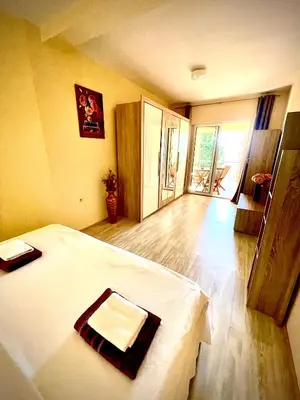 a bedroom with a bed and a large window at Holiday Home Viko in Sutomore