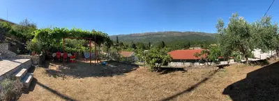 a yard with a playground with trees and a house at Holiday Home Bratica in Ulcinj