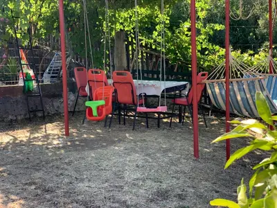 a group of chairs and a table in a park at Holiday Home Bratica in Ulcinj