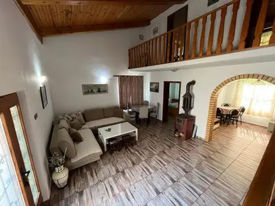 a living room with a couch and a table at Holiday Home Bratica in Ulcinj