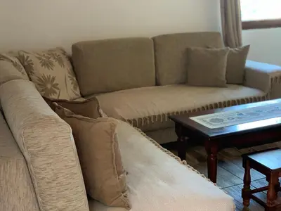 a living room with a couch and a table at Holiday Home Bratica in Ulcinj