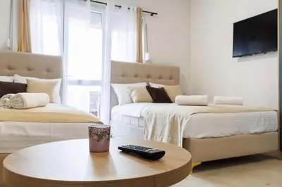 a living room with two beds and a coffee table at Apartments Donna in Bar